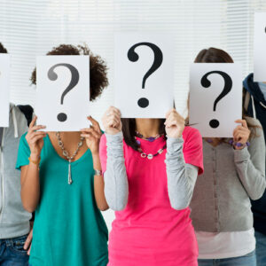 Five people holding question mark signs over their faces